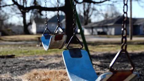 Empty-swings-swaying-in-a-school-playground