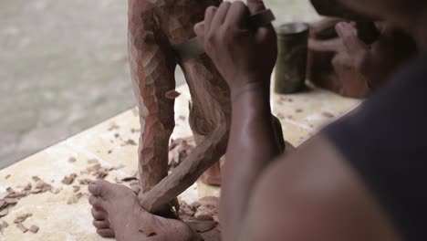 Man-making-a-wood-statue