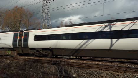 Footage-of-trains-approaching-Stoke-on-Trent-train-station-in-the-midlands-by-the-canal,-waterside-and-A50-motorway