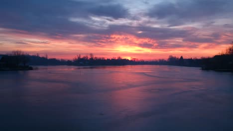 Sunrise-at-an-icey-lake-with-small-islands-in-winter-drone-footage-recorded-with-a-dji-spark-1080p-30fps