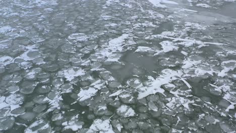 Drone-Flying-Backwards-Above-Iced-Over-Lake-In-the-Wind-and-Cold