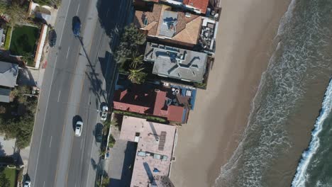 Afternoon-camera-down-drone-view-and-moving-slowly-down-towards-one-of-the-population-buildings-of-Malibu,-California