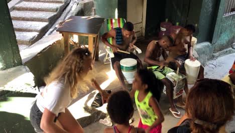 Young-blonde-woman-dancing-samba-with-kids-in-Rio-de-Janeiro,-Brazil