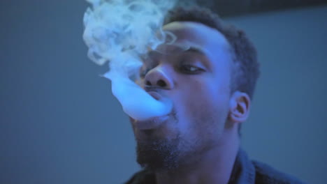 African-American-man-blowing-exhaling-smoke