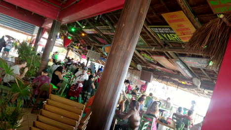People-Sitting-In-Busy-Tropical-Senior-Frogs-Restaurant-And-Bar-In-Mexico
