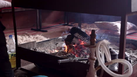 A-Fireplace-is-Burning-With-Shisha-Visible-in-the-Frame,-Slowmotion-100-Frames-Per-Second