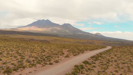 Establishing-cinematic-shot-following-a-dirt-road-in-the-Atacama-Desert,-Chile,-South-America