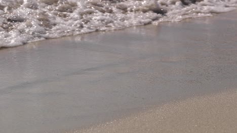 Static-Slowmotion-shoot-for-a-sea-wave-coming-in-a-sand-beach-in-Cagliari,-Sardinia