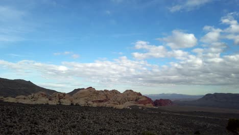 Slow-wide-pan-over-Red-Rocks-Canyon-from-Red-Rock-Canyon-Overlook,-Las-Vegas,-Nevada-on-a-sunny-spring-day