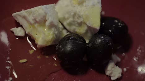 Olive-oil-drizzled-over-feta-cheese-and-black-olives