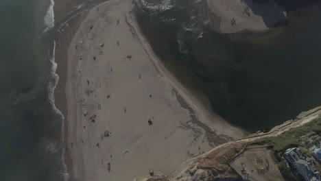 AERIAL---Tilt-Down-Drone-Shot-of-Beach-Cliff