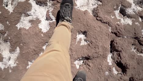 Hiker-feet-first-person-view-walking-on-salt-desert-in-Atacama-Region
