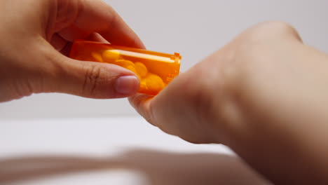 Pills-pour-out-onto-addict's-hand