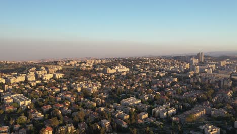 Israel,-Jerusalem-colorful-sky-over-city-buildings-view,-drone-aerial-shot