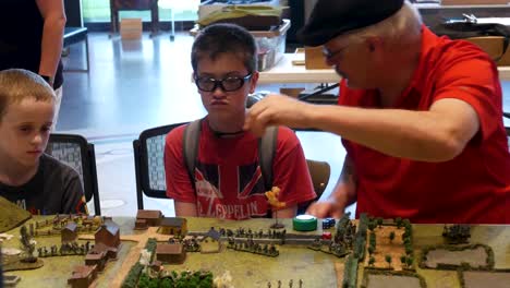 Adults-teach-young-people-how-to-play-tactical-civil-war-gaming
