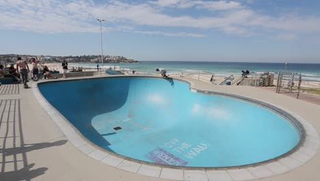 recreational-skater-riding-a-skateboard-in-the-skate-park-at-Bondi-Beach-in-Sydney-Australia-on-a-sunny-spring-day