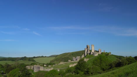 Slow-panning-shot-of-Corfe-Castle-in-early-morning-light,-Isle-of-Purbeck,-Dorset,-England