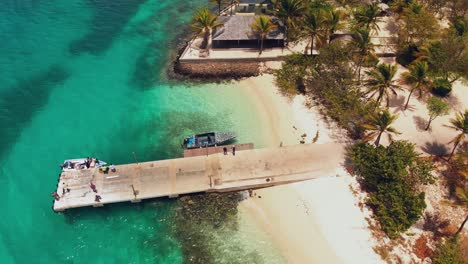 Drone-footage-of-epic-beach-with-boat-alongside-the-jetty-in-Petit-St-Vincent