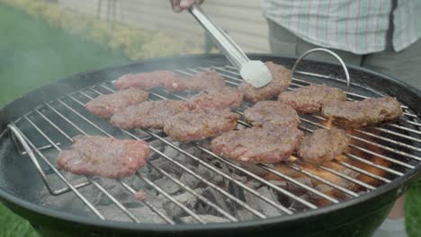 Turkish-minced-meat-also-known-as-meatball-or-kofte-is-being-cooked-on-a-grill-with-smoke