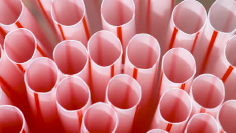 Macro-close-up,-pan-across-the-top-of-a-bunch-of-plastic-drink-straws