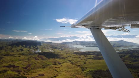 Flying-over-Papua-New-Guinea-highlands-view-of-Yonki-reservoir,-wing