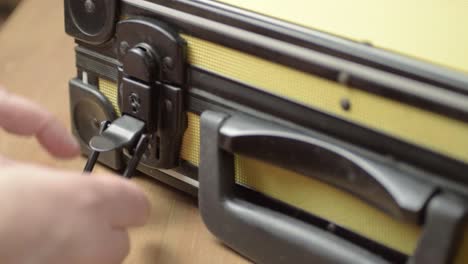 Hand-opening-a-case-with-catch-lock-mechanism