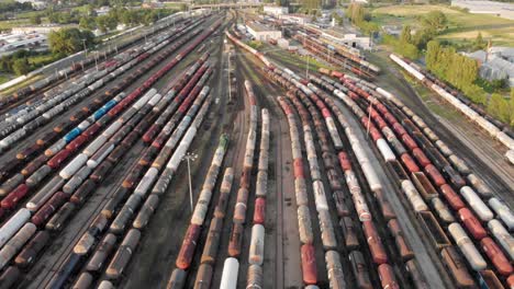 Aerial-dolly-shot-Showing-Large-Train-Depot-With-Many-colorful-cargo-Trains