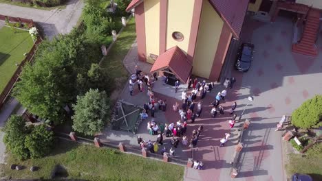 Aerial-shot-of-a-wedding-ceremony-in-a-small-church-on-a-coutryside