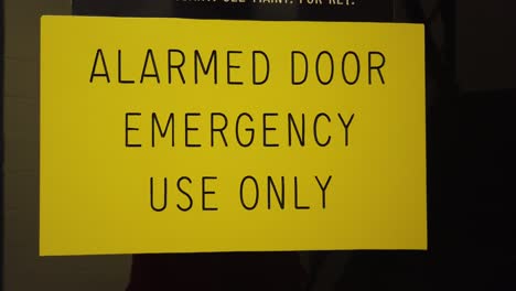 Footage-of-an-alarmed-door-use-only-sign