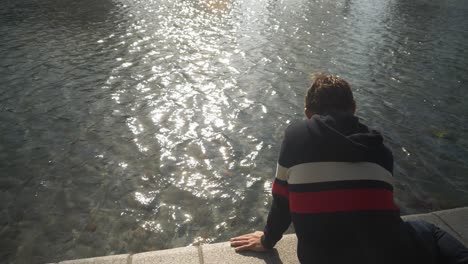 Young-man-enjoying-the-canal-in-Amsterdam