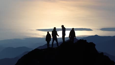 Silhoute-of-friends-taking-in-the-view-after-climbing-a-mountain