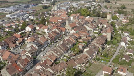 Aerial-side-overflight-of-Avenches-medieval-town-and-Roman-arena