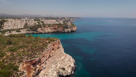 AERIAL:-Drone-flying-close-to-cliffs-of-mallorca-coast-in-sunny-summer