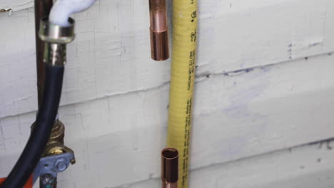 Copper-pipe-is-fitted-between-two-copper-couplers-during-a-water-pipe-repair
