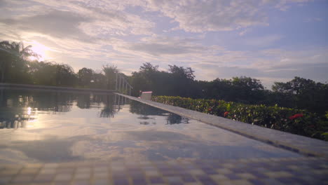 Beautiful-view-of-a-swimming-pool-in-natural-environment-at-sunset-in-Boca,-Chica,-Panama