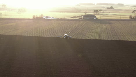 Luftaufnahme-Eines-Ackerschleppers,-Der-An-Einem-Sonnigen-Tag,-Schottland,-Ein-Feld-In-Aberdeenshire-Pflügt