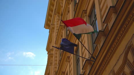 Wind-blows-Hungarian-and-European-Union-flags-waving-in-slow-motion-together