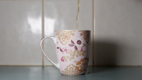 Tea-being-poured-into-a-decorative-tea-cup
