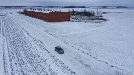 Aerial-view-over-driving-car-during-winter