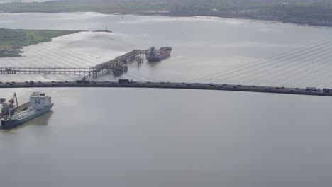 drone-shot-of-Queen-Elizabeth-II-Bridge-,-Dartford-Thurrock-River-Crossing,-high-view-of-traffic