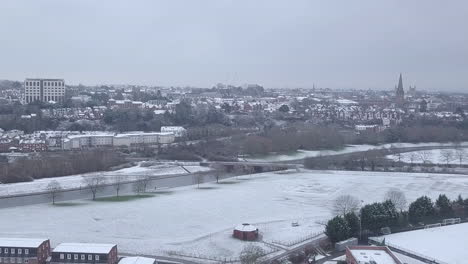 Track-backwards-drone-shot-of-snowy-Exeter-over-the-River-Exe-CROP