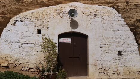 A-young-girl-approaches-the-door-of-the-Agois-Sozomenos-cave-church-in-Cyprus-Europe