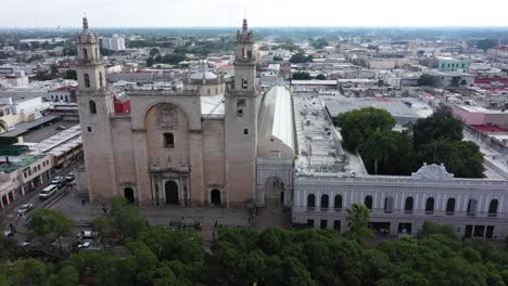 Aerial-camera-ascending-and-pitching-down-focussed-on-the-Cathedral-of-Merida-at-the-Grand-Plaza-in-Merida,-Yucatan,-Mexico-at-sunrise