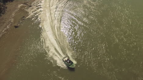 Speedboats-chasing-each-other-on-a-shallow-winding-river-with-friends