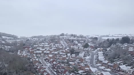 Ascending-dolly-forward-drone-shot-of-snowy-Exeter-subburbs-CROP