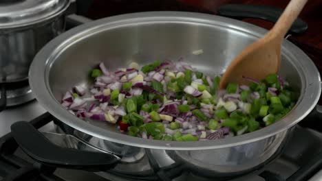 Chef-stirring-diced-onions-and-celery-in-a-pan-with-olive-oil-CLOSE-UP