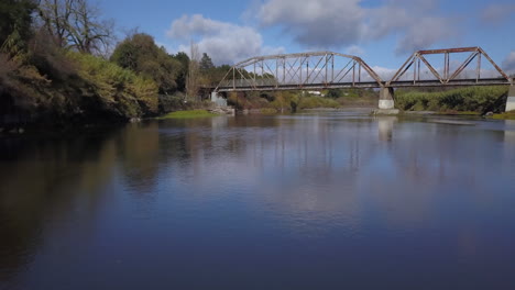 Drone-flying-underneath-new-Truss-bridge-with-old-bridge-in-the-background-on-Russian-River-in-Healdsburg-California