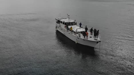 Menschen-Angeln-Vor-Einem-Verankerten-Kreuzfahrtschiff-In-Der-Bucht-Von-Marlborough-Sounds,-Neuseeland