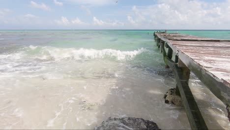 A-slow-motion-over-an-old-vintage-pier-at-a-tropical-beach