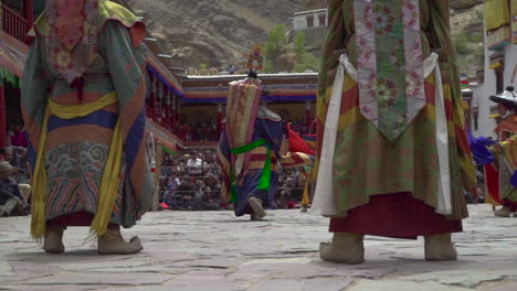 Monks-wearing-colorful-masks-and-dresses-performing-dances-infront-of-tourists-at-Hemis-festival-in-monastery